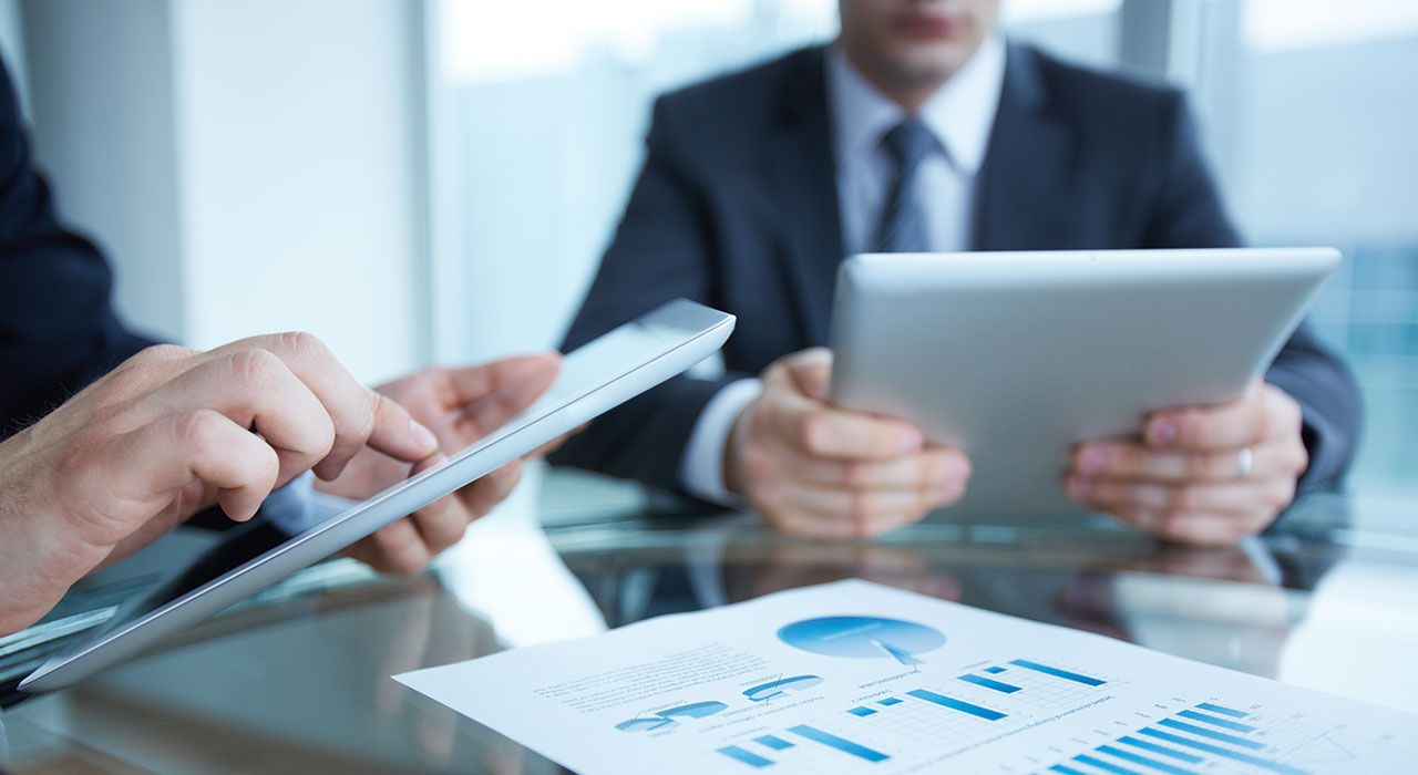 business-people-on-tablets-doing-financials